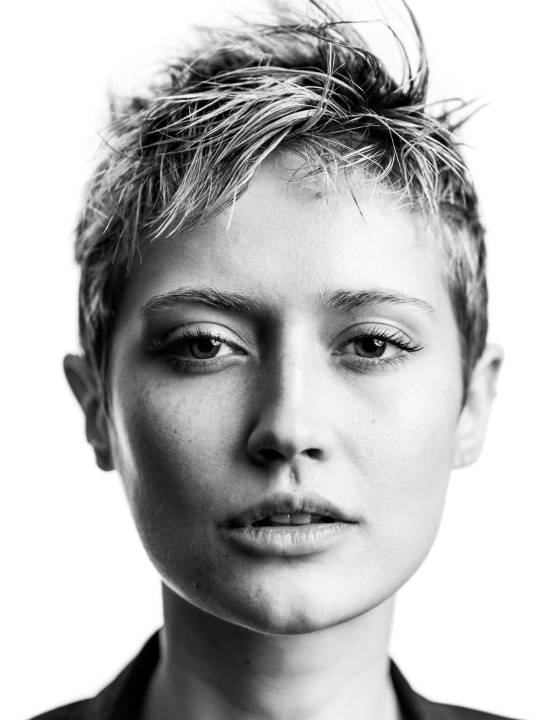 Headshot of a woman with short blonde spikey hair in front of a white background by portrait photographer Andy Barnham
