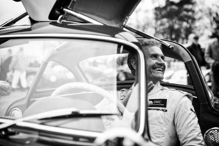 Lifestyle portrait of British former F1 racing driver David Coulthard sitting at the wheel of a classic gull wing sports car by portrait photographer Andy Barnham