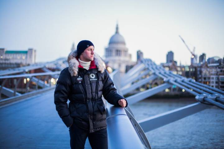 Lifestyle portrait of Scott Sears MBE, youngest person to reach the South Pole solo, standing on London's Millennium Bridge with St Paul’s Cathedral in the background. Portrait by portrait photographer Andy Barnham.