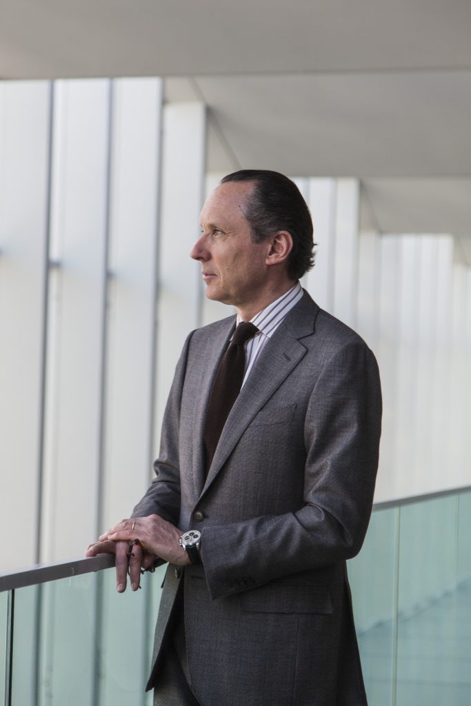 Lifestyle portrait of Gildo Zegna, Chairman and CEO of Ermenegildo Zegna Group in suit standing in the Zegna headquarters in Milan by portrait photographer Andy Barnham