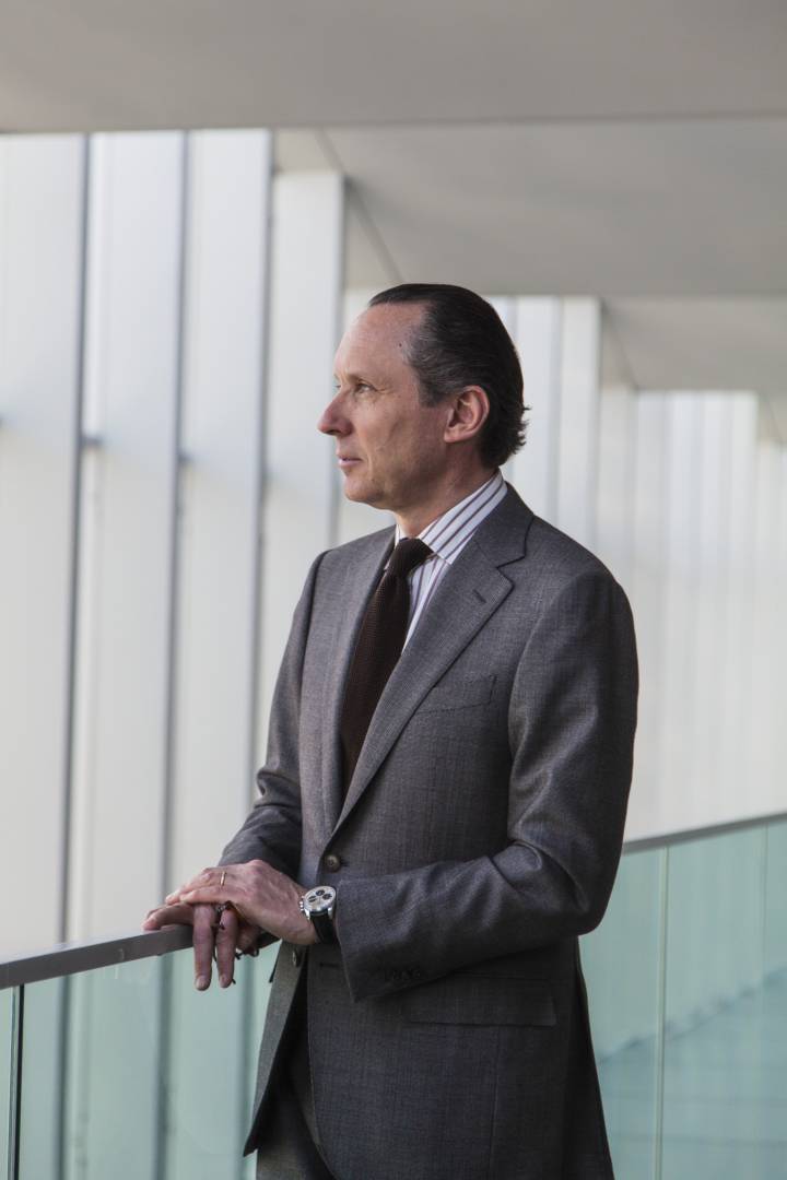 Lifestyle portrait of Chairman and CEO of Ermenegildo Zegna Group Gildo Zegna in suit standing in a modern architecture building by portrait photographer Andy Barnham