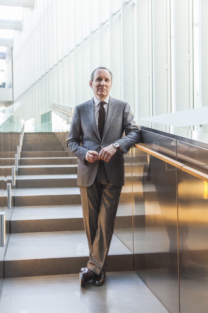 Lifestyle portrait of Gildo Zegna, Chairman and CEO of Ermenegildo Zegna Group in suit standing on a staircase in the Zegna headquarters in Milan by portrait photographer Andy Barnham
