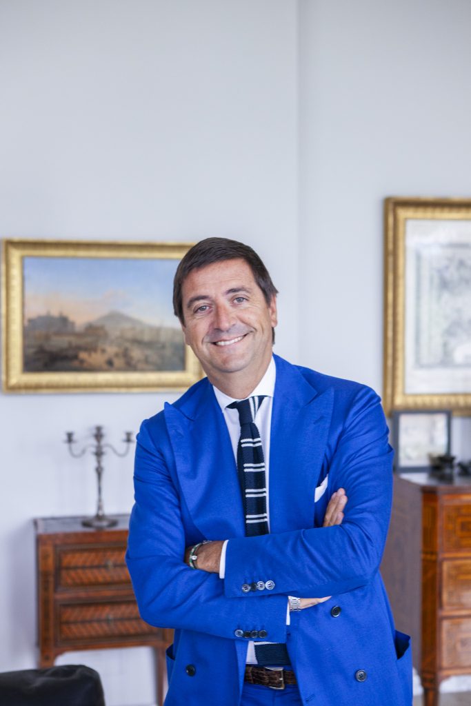 Antonio De Matteis CEO of the Kiton Group standing in his office with his arms folded by portrait photographer Andy Barnham