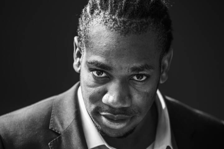 Lifestyle portrait of black Jamaican sprinter Yohan Blake in shirt and jacket by portrait photographer Andy Barnham