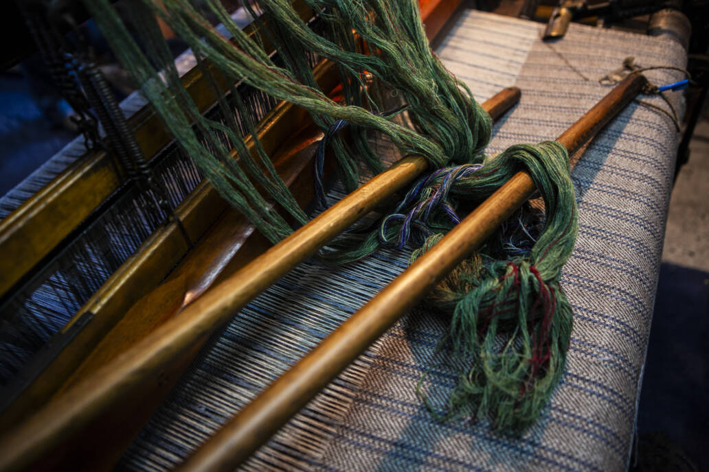 Tweed being woven on a manual wooden loom