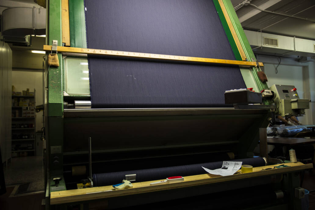 Newly woven piece of cloth on a loom ready for quality inspection