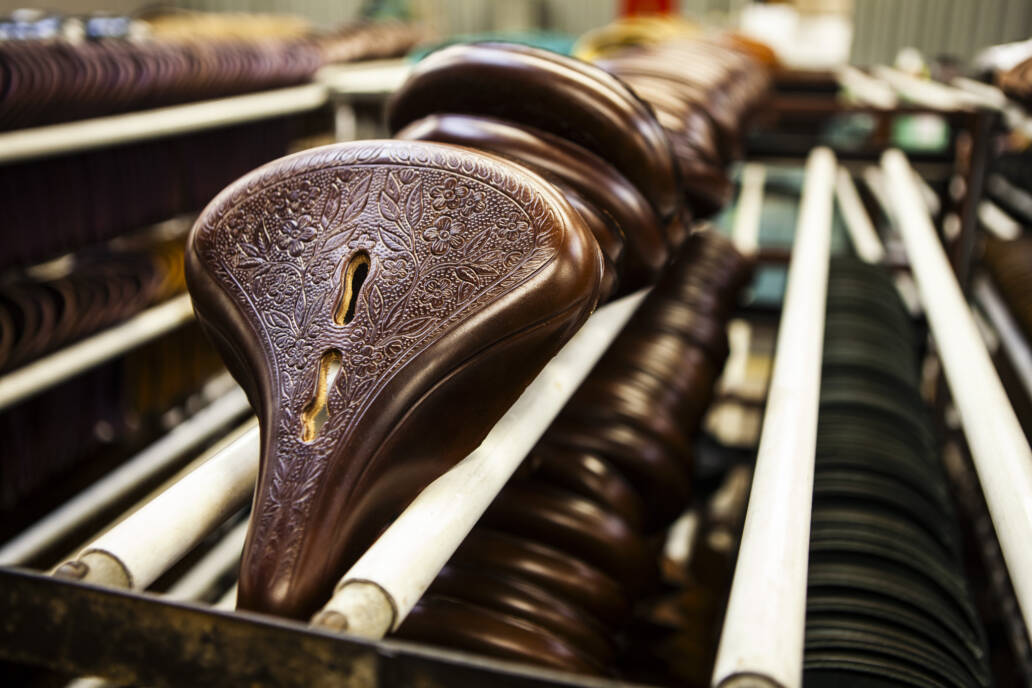 Rows of bicycle saddles in factory