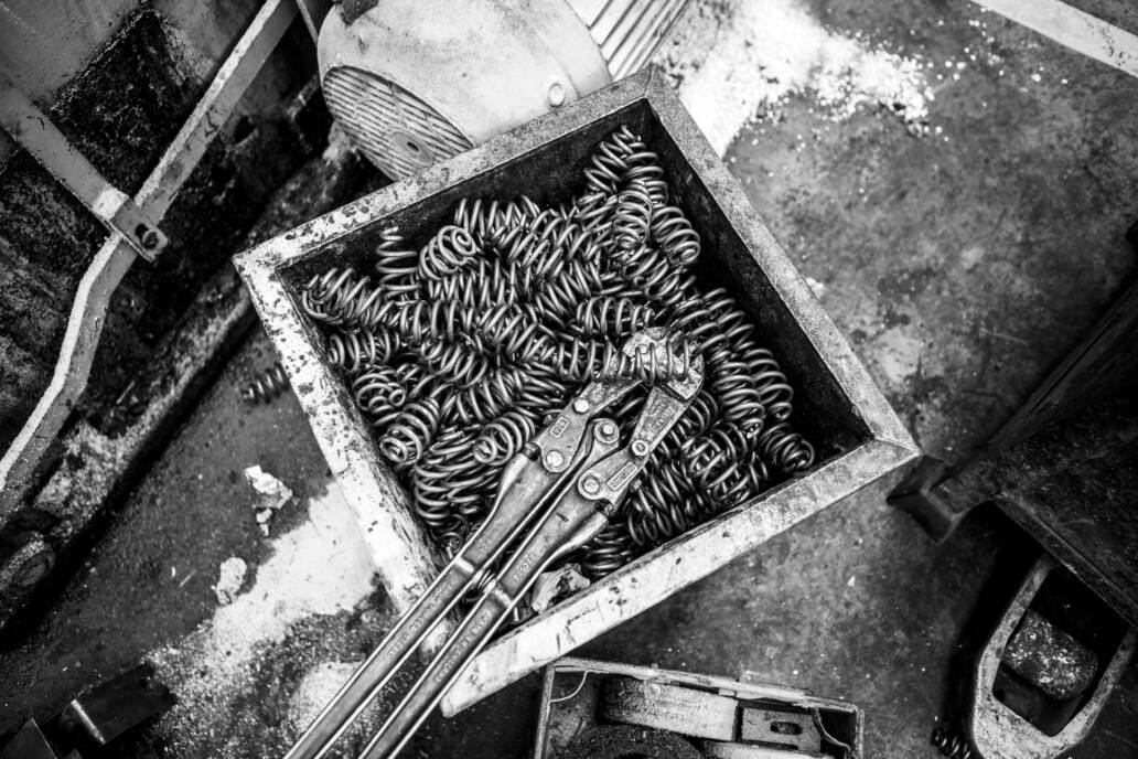 Metal springs in box with bolt cutter