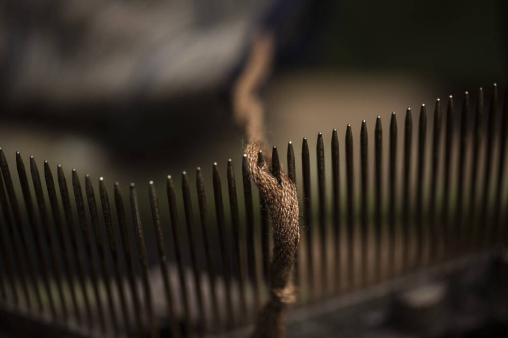 Close up of thread on tenters on a loom