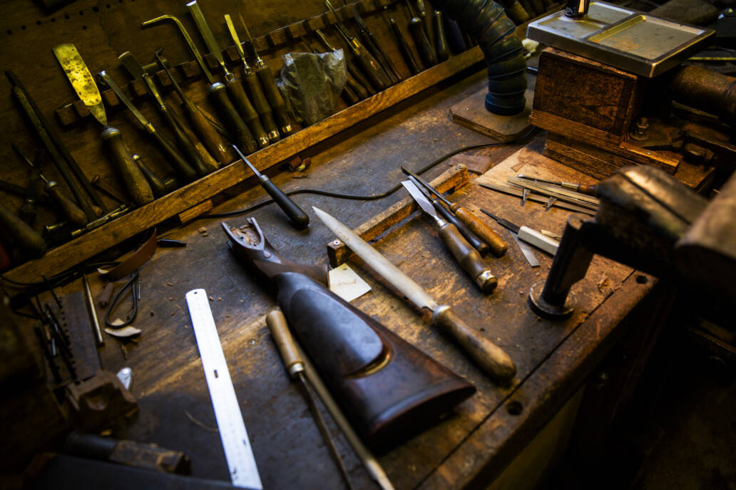 Bespoke shotgun butt on worktop surrounded by tools
