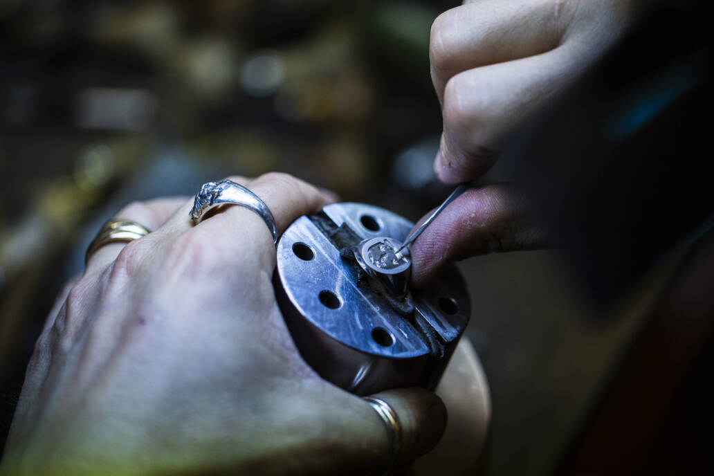 Man hand engraving a signet ring