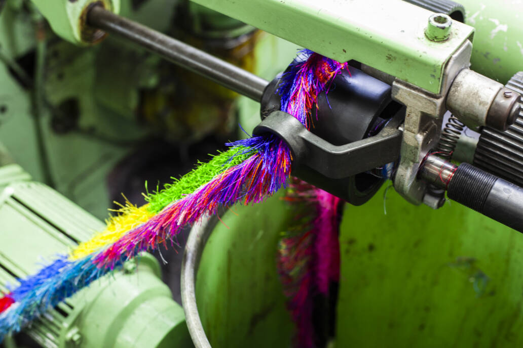 Thread offcuts on a green loom