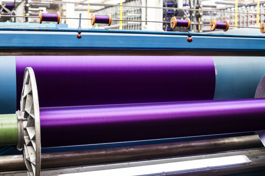 Newly woven purple cloth on a loom