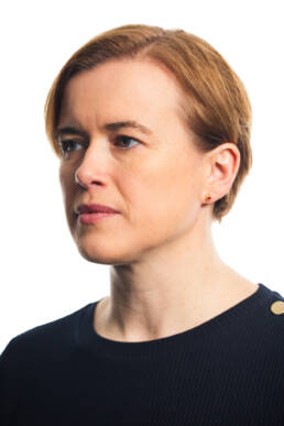 Headshot of a woman with short brown hair looking to her right